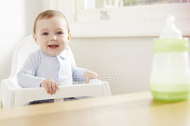 Portrait of baby boy on high chair — Stock Photo