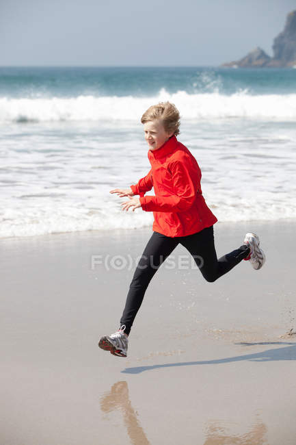 Ragazzo che corre sulla spiaggia — Foto stock