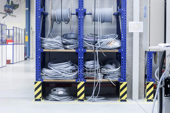 Electrical cables on shelf in engineering plant — Stock Photo