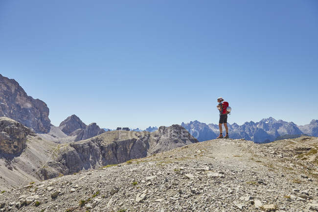 Rear view of female hiker looking out at Dolomites, Sexten, South Tyrol, Italy — Stock Photo