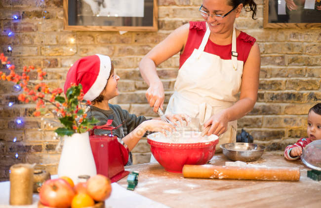 Mother and son making Christmas cookies at home — Stock Photo