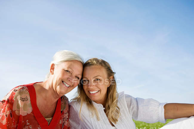 Adult mother and daughter sitting together — Stock Photo