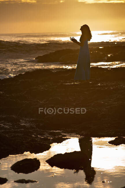 Woman standing on rock formations — Stock Photo