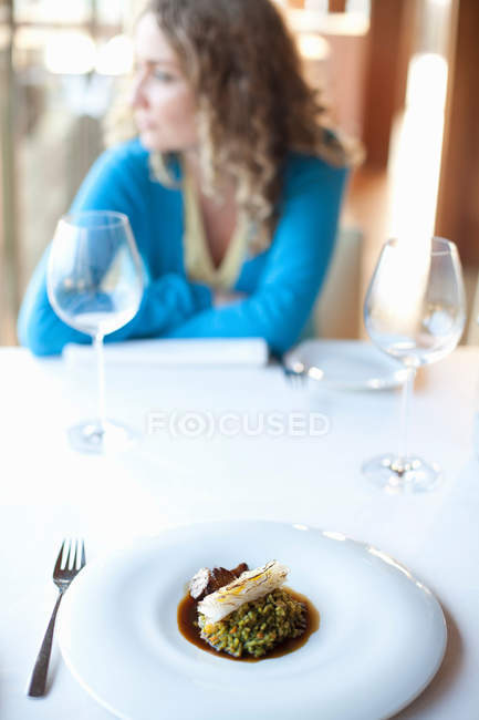Plate of paella at restaurant table — Stock Photo