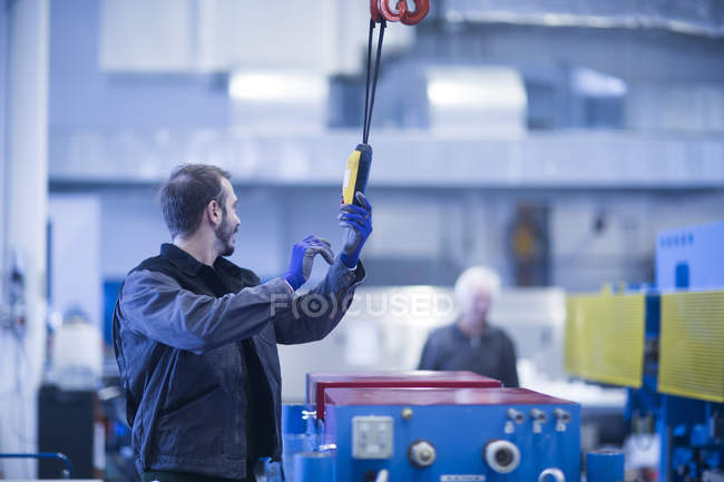 Young adult male Engineer operating heavy machinery — Stock Photo