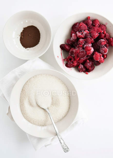 Bowls of fruit, sugar and cocoa — Stock Photo