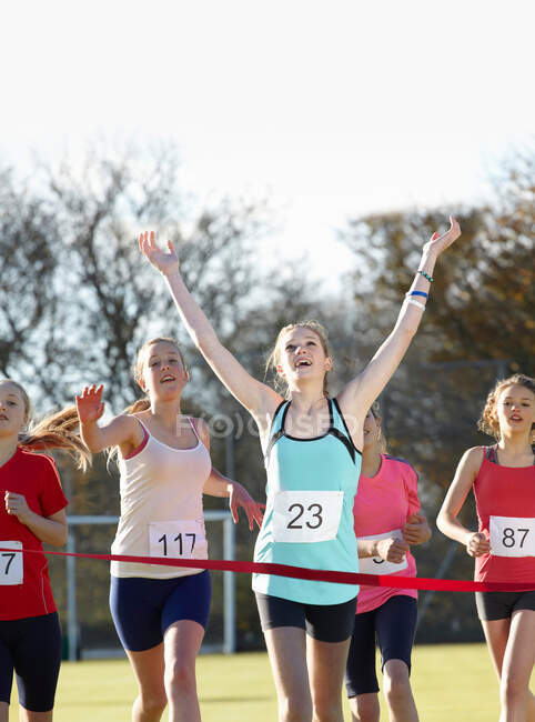 Runner crossing finish line in field — Stock Photo