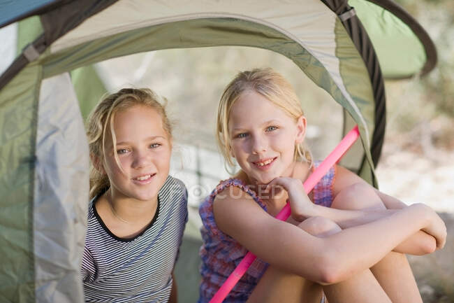 Girls holding hula hoops in tent — Stock Photo