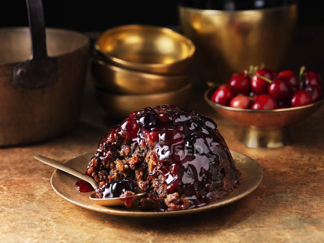 Eaten black forest christmas pudding with spoon on plate — Stock Photo