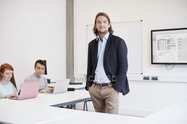 Portrait of male lecturer in higher education college classroom — Stock Photo