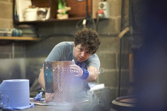 Male caucasian Glassblower creating artwork — Stock Photo
