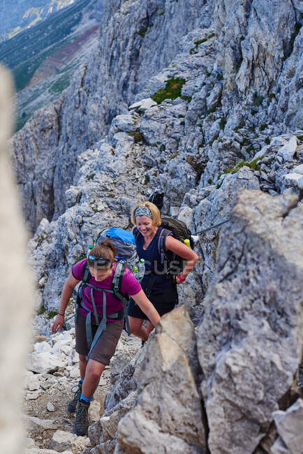 Group of women hiking up mountain smiling, Austria — Stock Photo