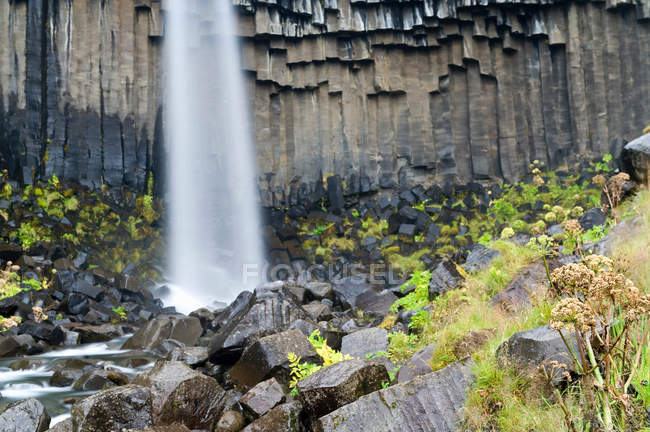 Waterfall over rock formations — Stock Photo