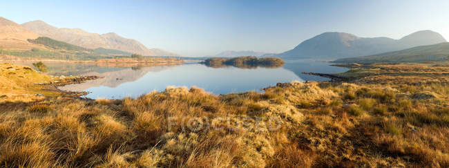 Montañas reflejadas en lago inmóvil - foto de stock