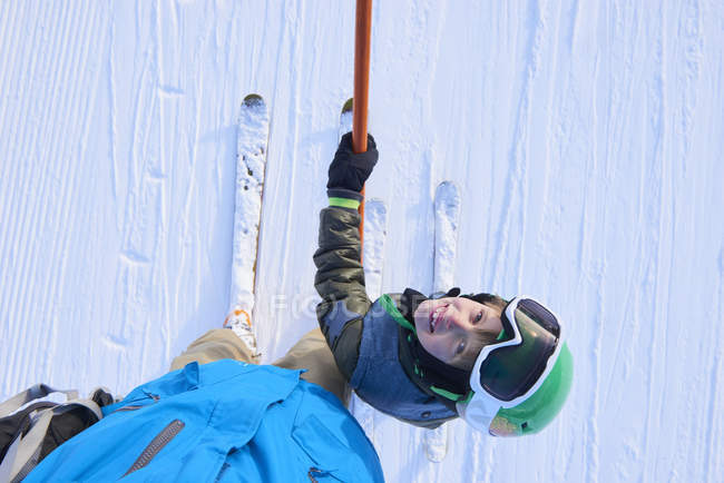 Overhead portrait of boy skier looking up at father, Gstaad, Switzerland — Stock Photo