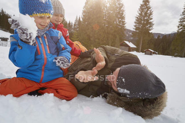 Father and sons having snowball fight in winter, Elmau, Bavaria, Germany — Stock Photo