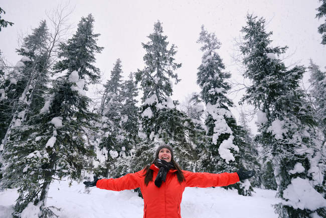 Young woman celebrating in snow covered forest, Posio, Lapland, Finland — Stock Photo