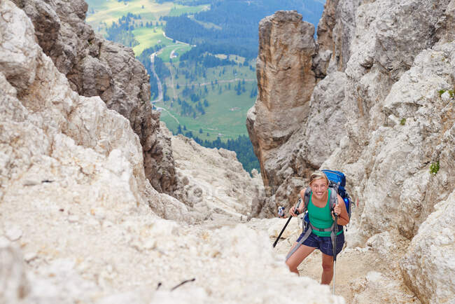 Woman hiking up mountain looking at camera smiling, Austria — Stock Photo