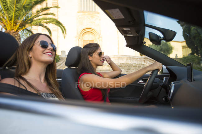 Two young women tourists driving convertible, Calvia, Majorca, Spain — Stock Photo