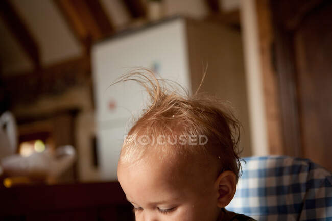 Toddler boy in high chair — Stock Photo