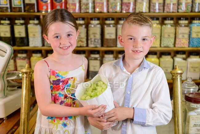 Children holding bag of confectionery — Stock Photo