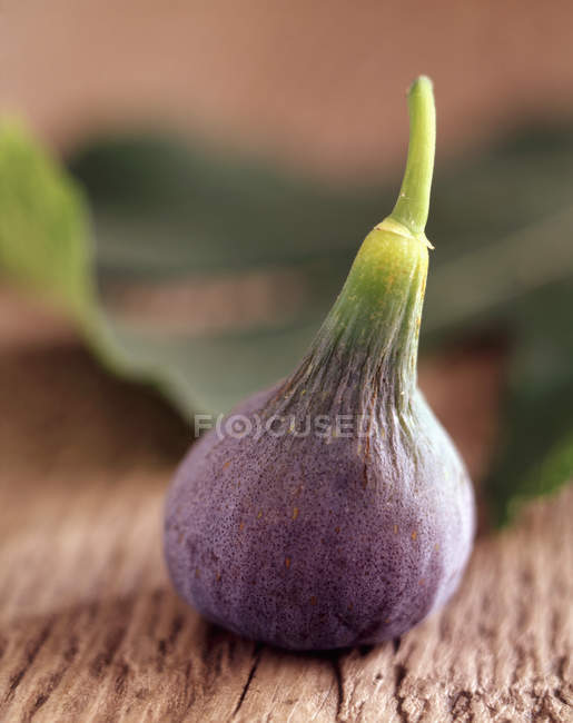 Close up shot of purple fig on rustic wooden table — Stock Photo
