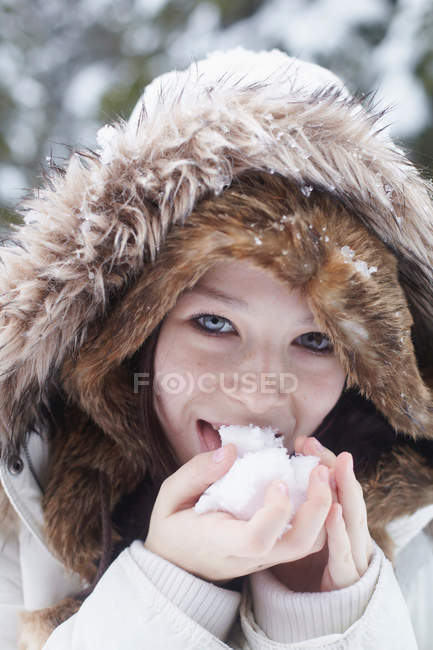 Teenage girl licking snowball — Stock Photo