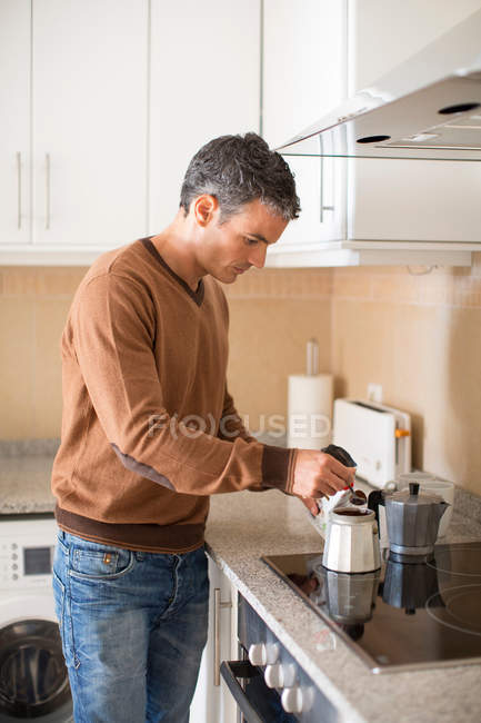Homme faisant du café dans la cuisine — Photo de stock