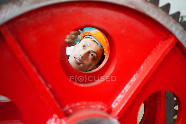 Worker using equipment in crane manufacturing facility, China — Stock Photo
