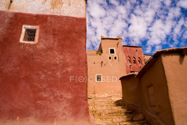 Colorful ancient buildings and blue cloudy sky — Stock Photo