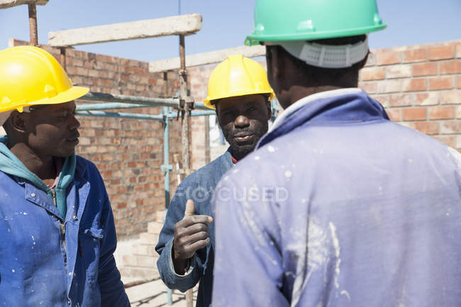 African Builders talking on construction site — Stock Photo