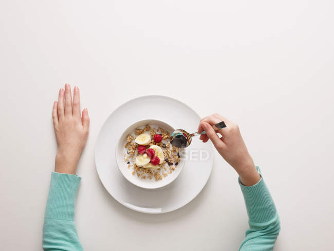 Top view of Hands by a bowl of cereal — Stock Photo