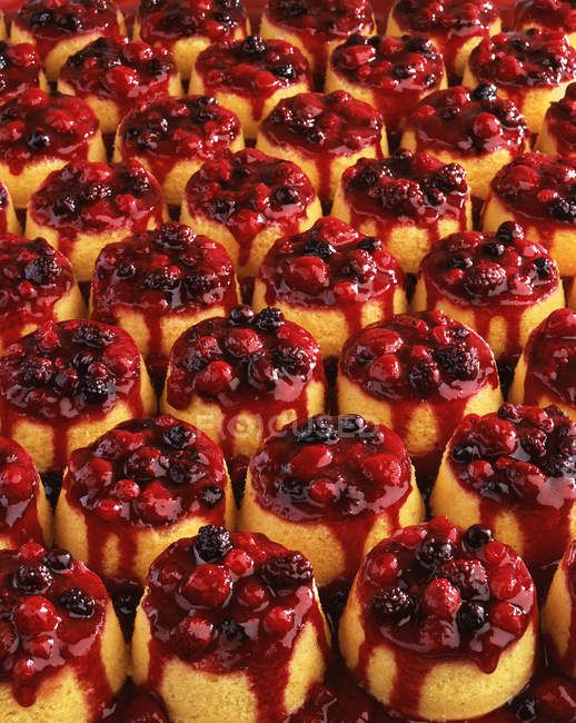Rows of fresh cooked fruit steamed puddings — Stock Photo