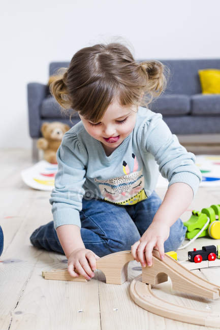 Girl playing with toy cars at home — Stock Photo