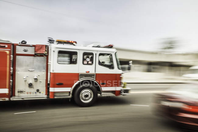 Blurred motion shot of speeding fire engine — Stock Photo
