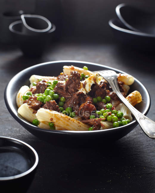 Pasta dish with meat and peas — Stock Photo