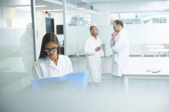 Male and female doctors at work in office — Stock Photo