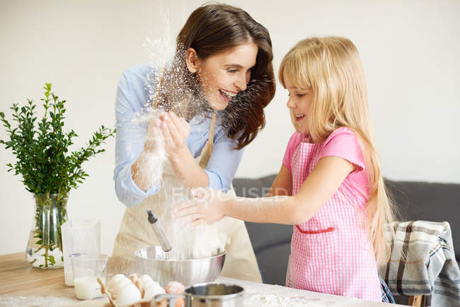 Mother and daughter baking together, fooling around — Stock Photo