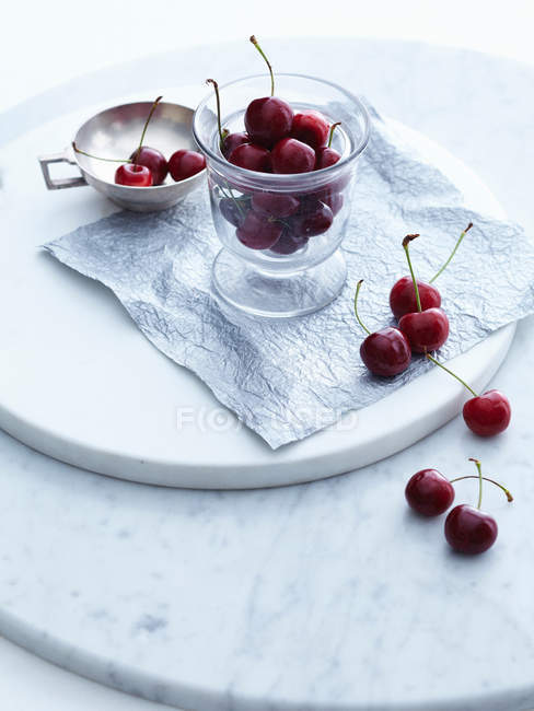 Cup of cherries on tray — Stock Photo
