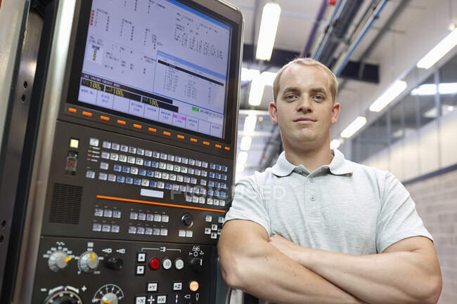 Portrait of engineer and control panel in engineering factory — Stock Photo