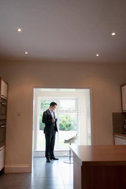 Businessman standing in foyer — Stock Photo