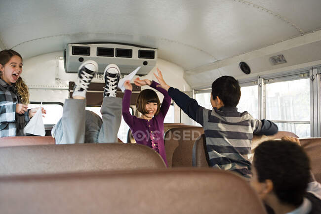 Children having fun on school bus — Stock Photo