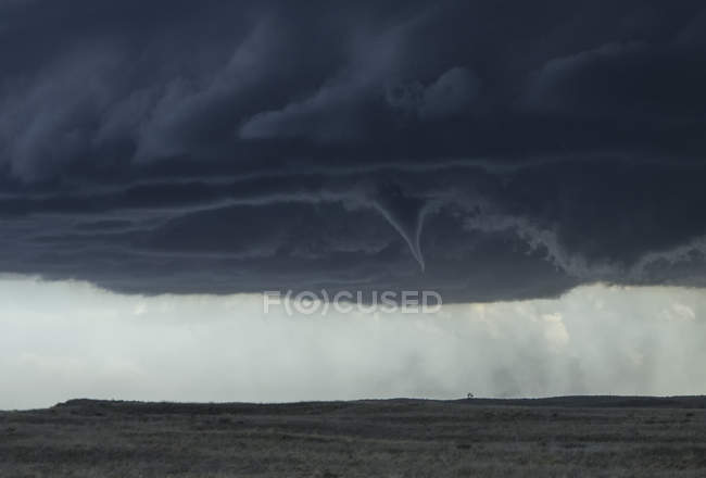 Funnel cloud in sky above open prairie — Stock Photo