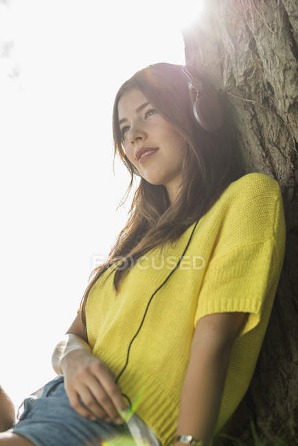 Young woman wearing headphones, portrait — Stock Photo