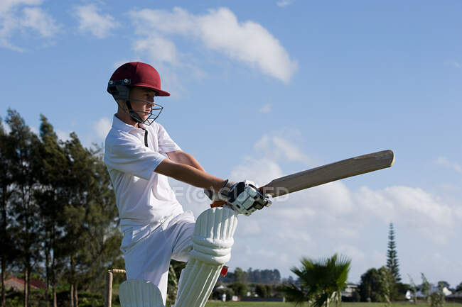 Auckland, jugador de cricket con bate en el patio - foto de stock