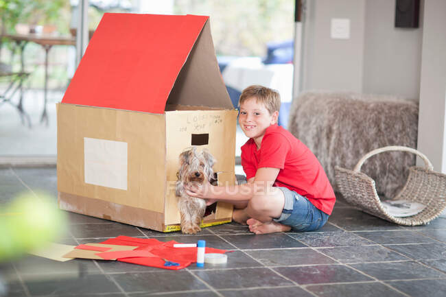 Boy building kennel for his dog — Stock Photo