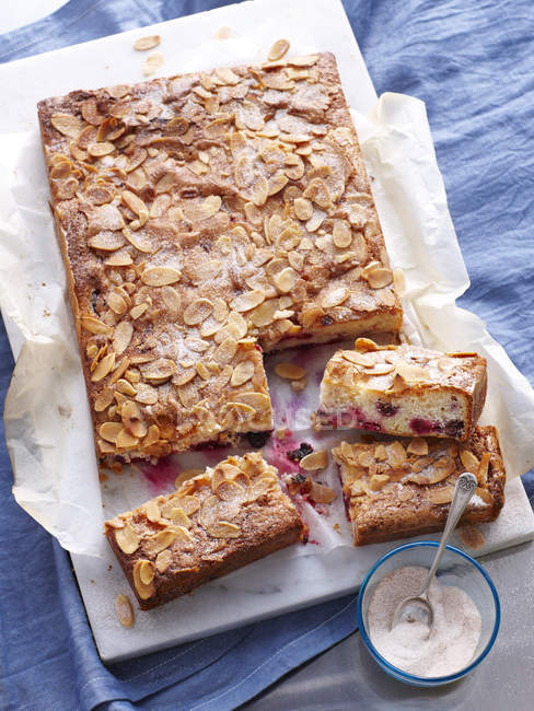 Still life of berry pie slices topped with almonds — Stock Photo