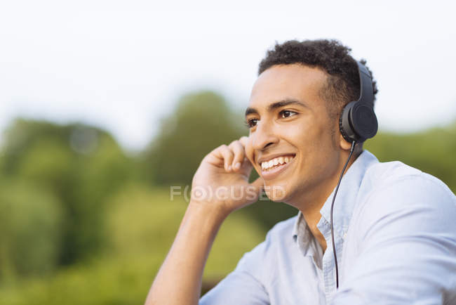 Homme portant des écouteurs détournant les yeux — Photo de stock