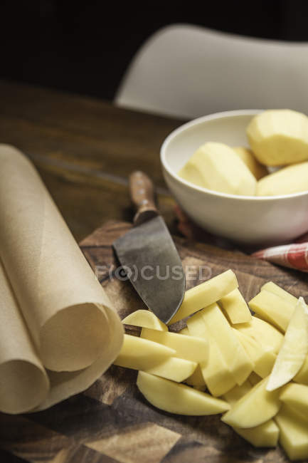 Nature morte de pommes de terre pelées et tranchées et couteau de cuisine — Photo de stock