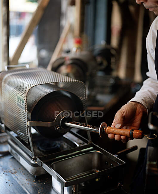 Man roasting coffee beans — Stock Photo